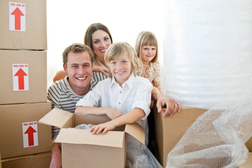 Local movers handling furniture in a Gospel Oak flat