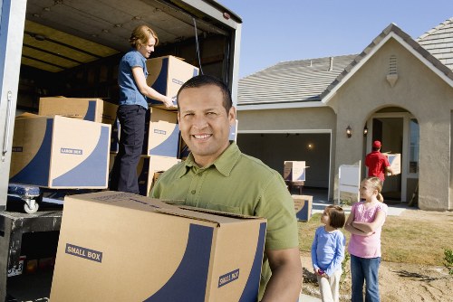 Moving team managing furniture and boxes near Gospel Oak homes